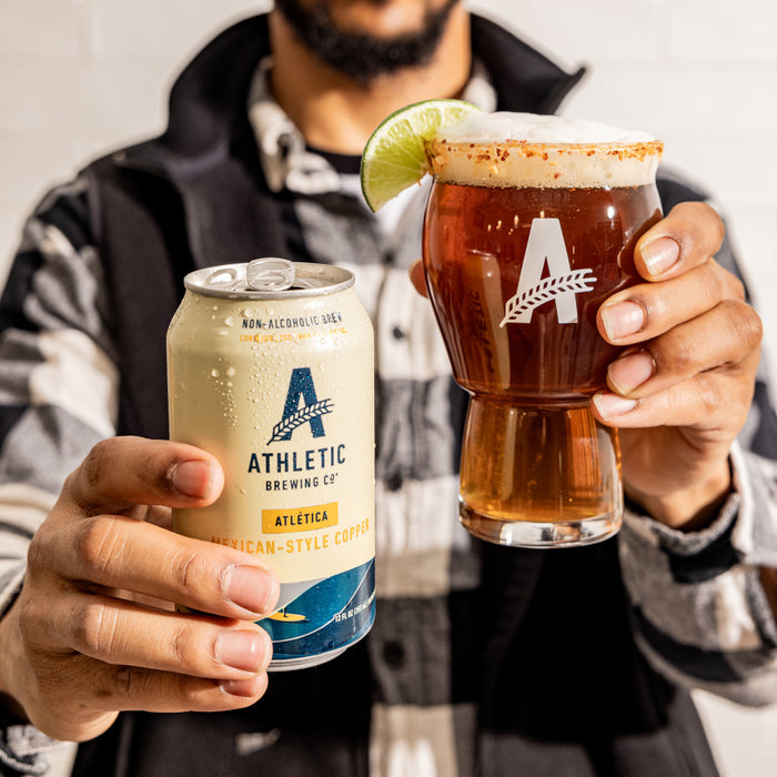 a customer holding a can and aglass of beer unsing the lime & Salt rimmer