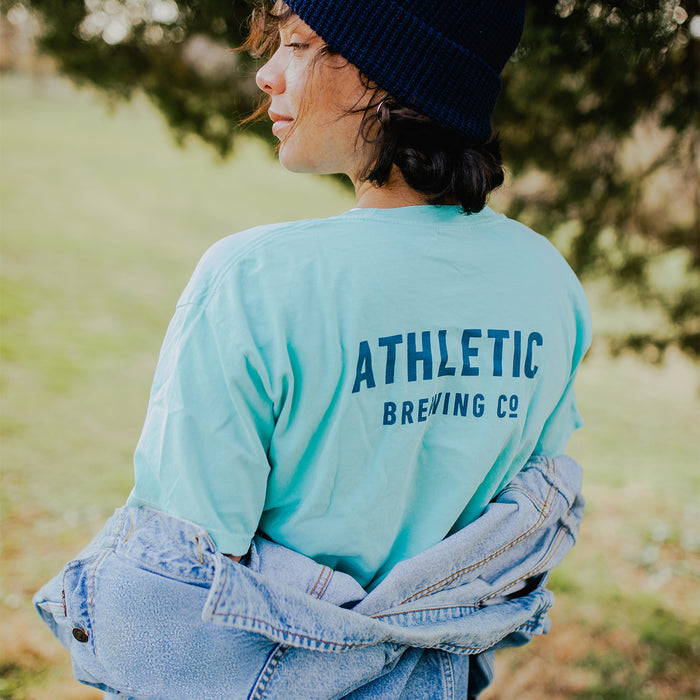 A customer wearing Athletic brewing co t-shit on on a park