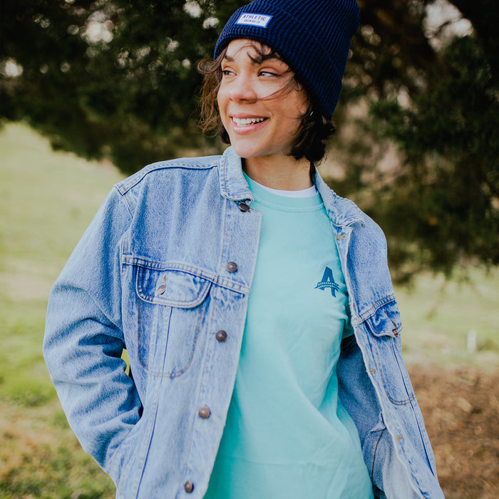 A customer wearing Athletic brewing co t-shit on on a park