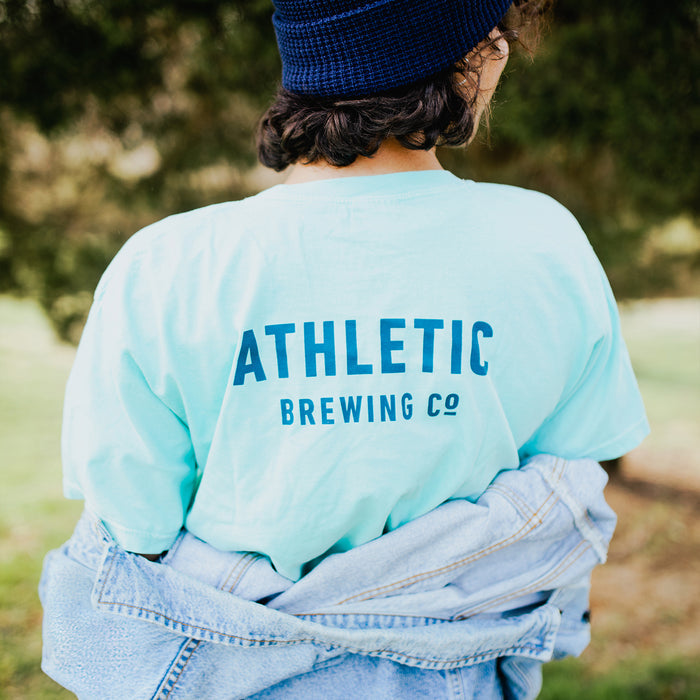 A customer wearing Athletic brewing co t-shit on on a park