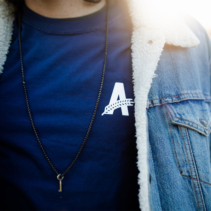 a navy t-shirt with Athletic Brewing logo close up shot
