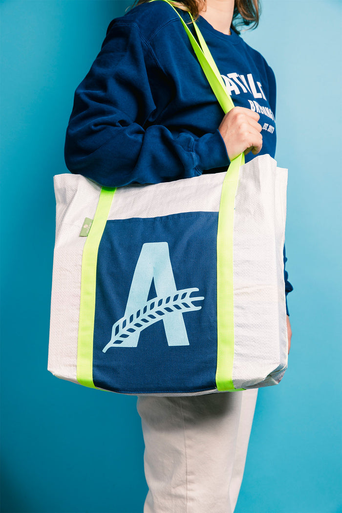 a customer holding an Athletic brewing co grain tote bag