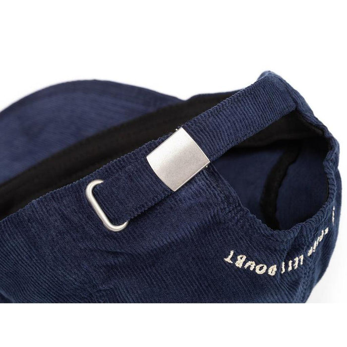 Close-up of the adjustable strap and metal buckle on the BSD More Speed Cap, highlighting quality details on this classic navy blue corduroy 6-panel hat.