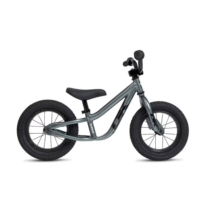 The DK Nano Balance Bike features a gray frame with black handlebars, saddle, and thick black tires. Shown in profile against a white background, it’s an ideal kids' balance bike for beginners.