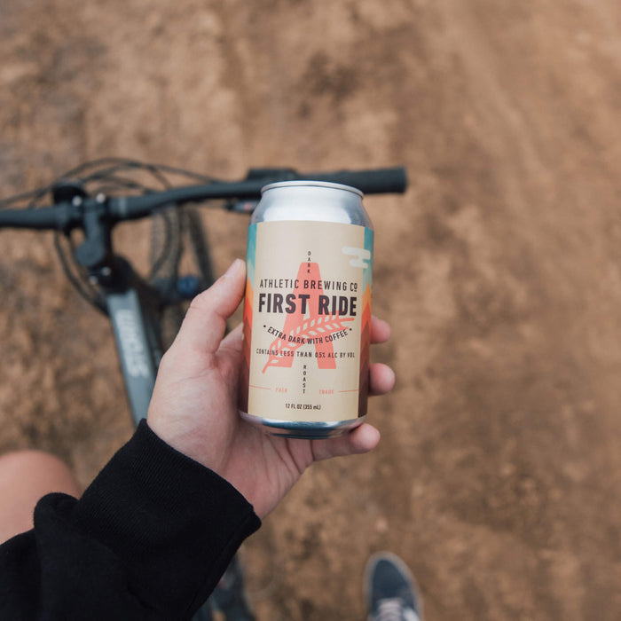holding can of first ride while on a bike