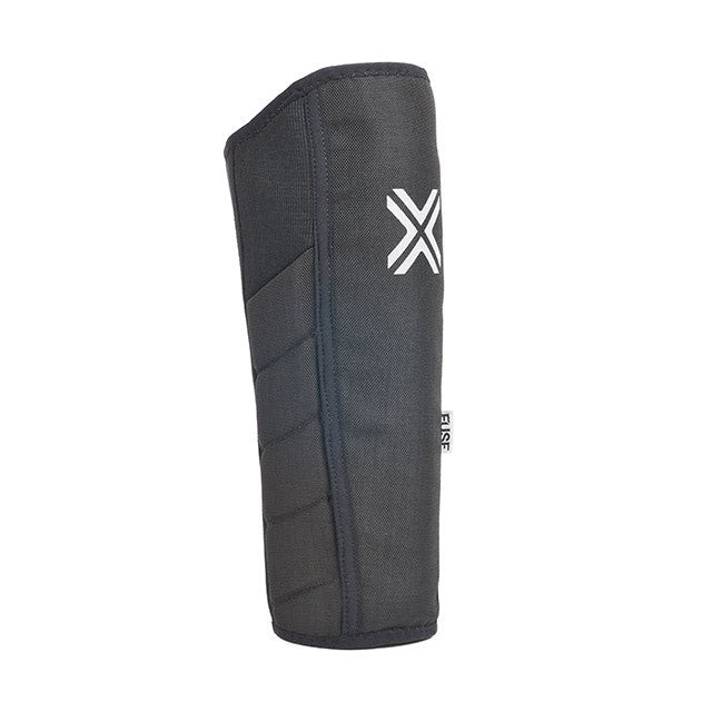 The Fuse Alpha Shin Whip Pads (Pair) are black protective pads with a white "X" logo, shown upright against a white background, designed for effective pedal bite protection.