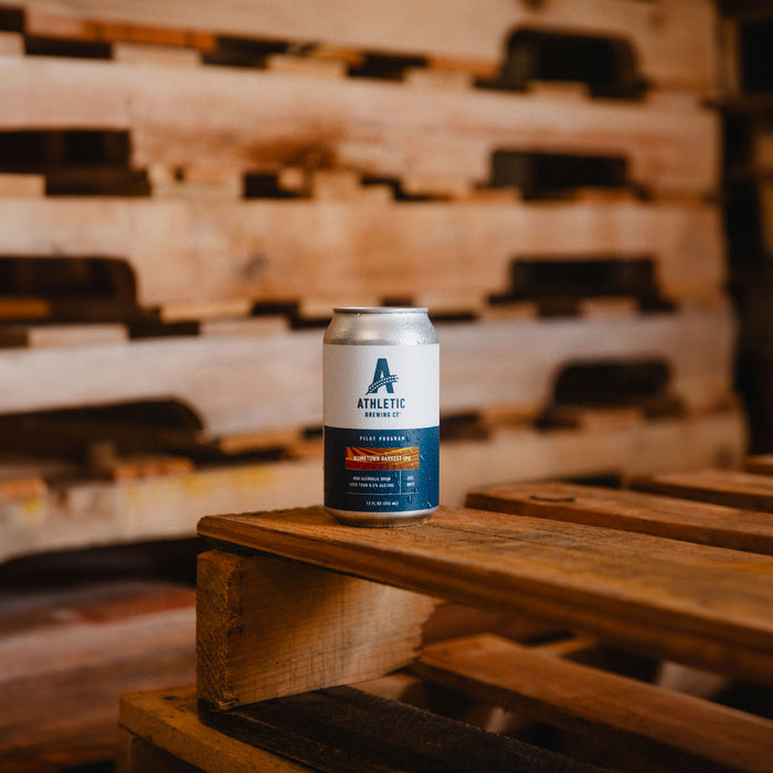 Hometown Harvest IPA can on top of a pallet in a warehouse setting