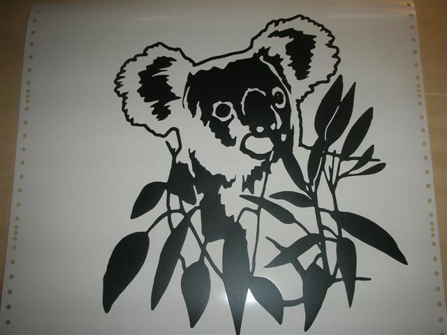 a black and white picture of a koala on a branch
