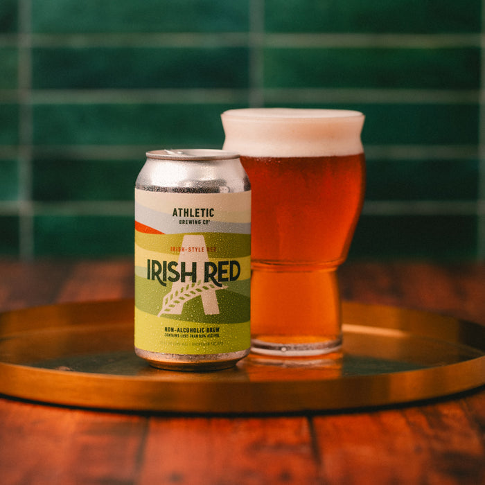 Irish Red can and full glass on gold tray.