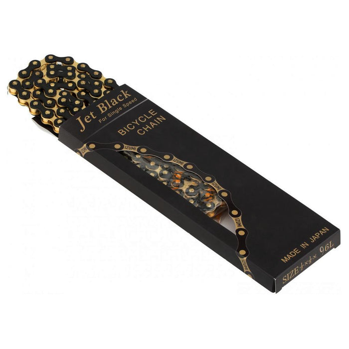 An Izumi 1/2 x 1/8 Inch Chain in jet black, ideal for use as a track or BMX chain, is shown partially out of its distinctive black and gold box, which displays the size and origin information on the packaging.