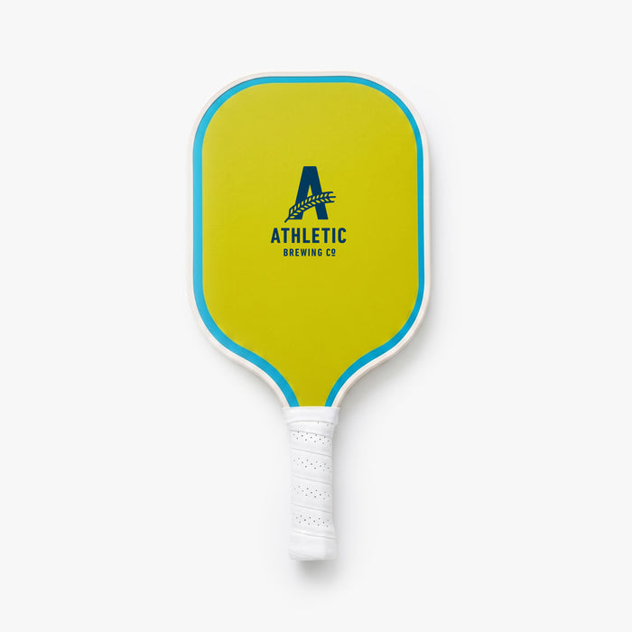 Front view of a neon yellow pickleball paddle with turquoise trim, a white handle wrap, and the Athletic Brewing Co. logo centered on the paddle face.