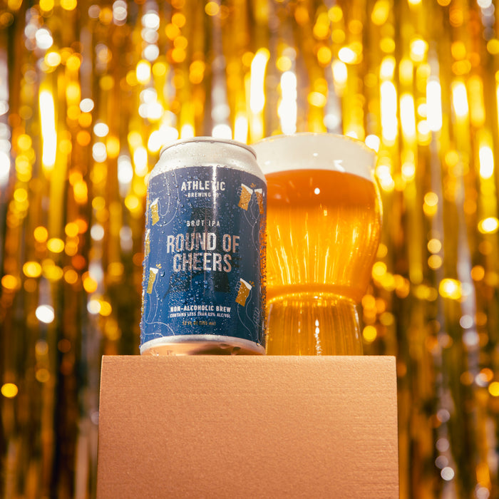 Round of Cheers can placed next to a glass in a celebratory setting, such as a holiday or party environment.