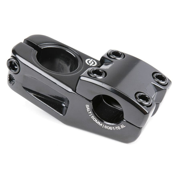 The Salt Am V2 Top Load Stem (22.2mm Clamp) is a black aluminum BMX stem featuring a four-bolt faceplate and side cutouts, labeled “SALT 50MM / 6061-T6 AL.” Precision-crafted from durable 6061-T6 alloy, it provides secure shark tooth clamping for reliable handlebar grip.
