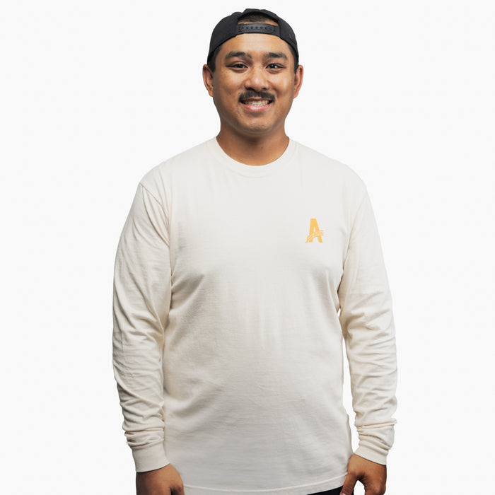 a happy man wearing Athletic brewing co, tan long sleeve t-shirt