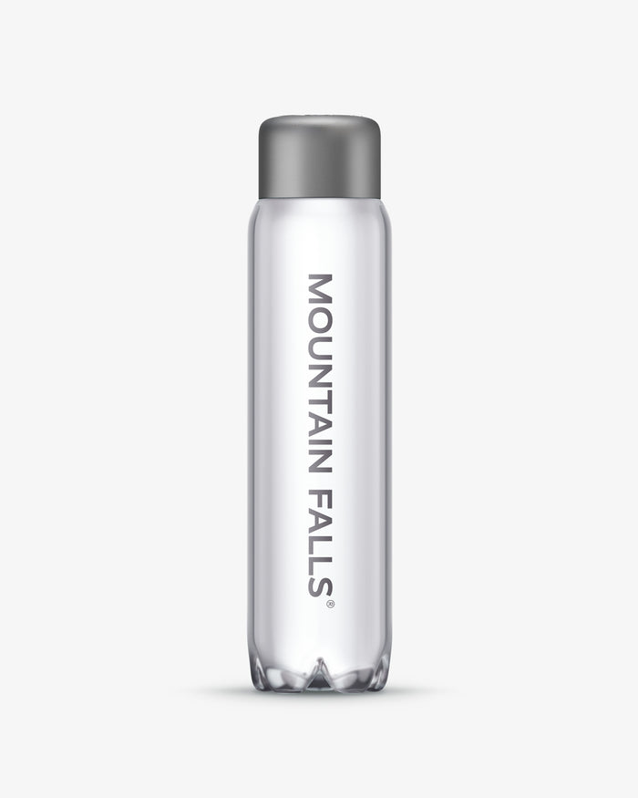 A 500ml clear sparkling mineral water bottle with the brand name 'Mountain Falls' printed on it.